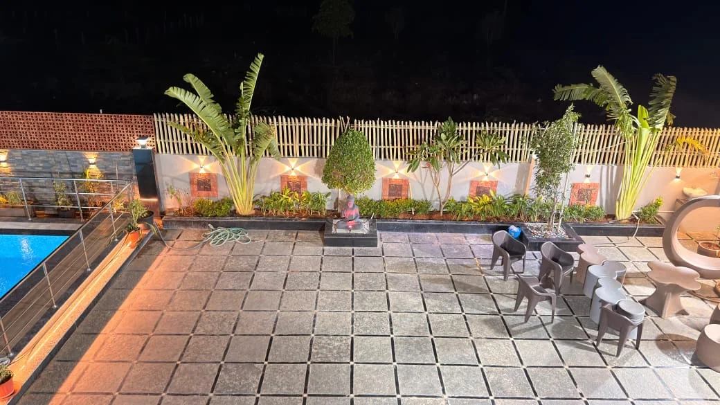 Outdoor terrace seating surrounded by resort landscaping