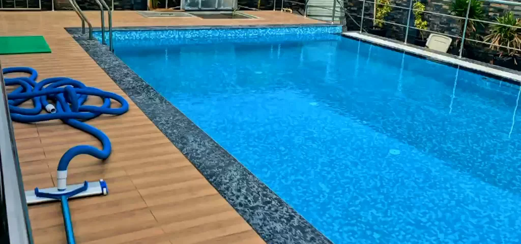 Swimming pool, decking and railings in daylight