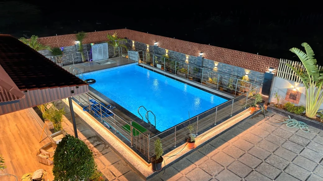 Evening view of the swimming pool at AVULA’S RESORTS